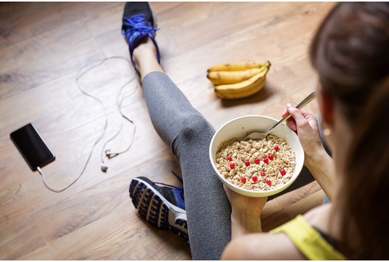 Young girl eating a oatmeal with berries